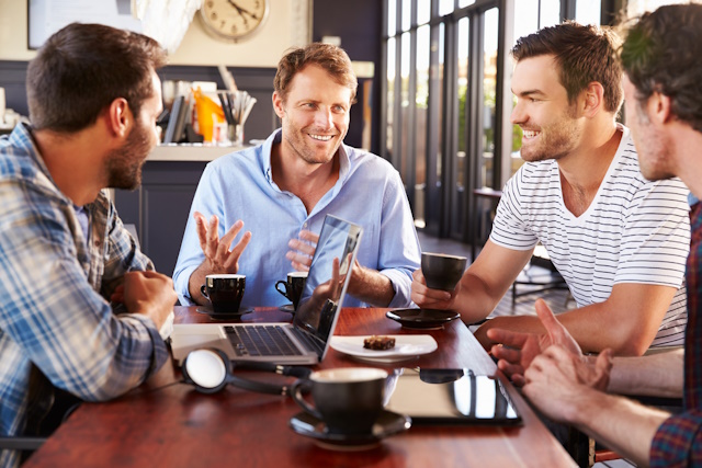 Group of men talking at a coffee shop