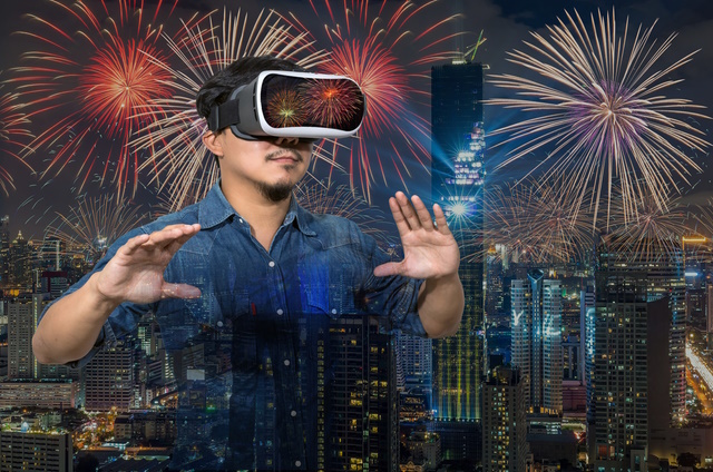 Double exposure of Asian man wearing virtual reality over the Top view of Bangkok Cityscape with Multicolor Firework Celebration at night, Mahanakhon, VR concept