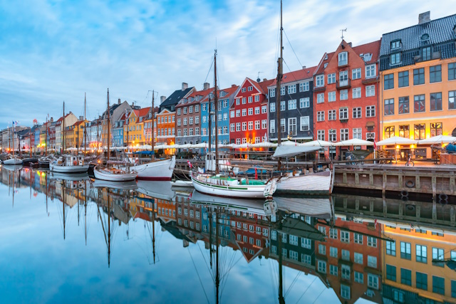 Photography Reflections Tips-How to Capture Beautiful Photos- Nyhavn with colorful facades of old houses and old ships in the Old Town of Copenhagen, capital of Denmark.