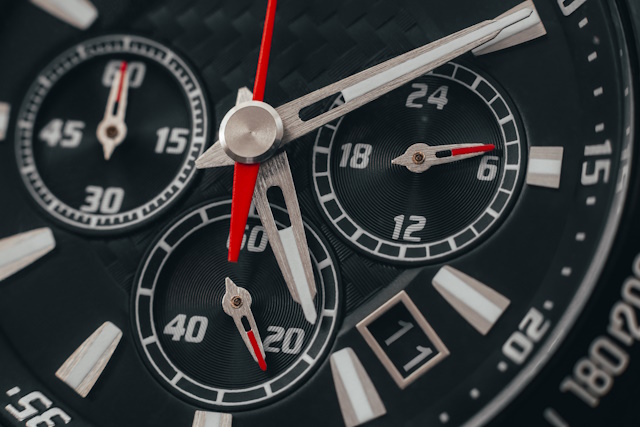 product photography ideas - Black watch case and dial. Wristwatch with red arrows close-up. Macro