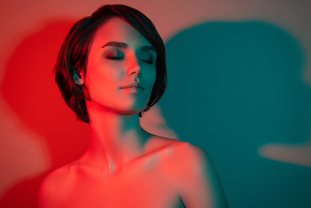 Color Gel Photography: Tips for Spectacular Shots - Photo of dreamy tempting pretty short hairstyle woman close eyes enjoy isolated red neon light color background.